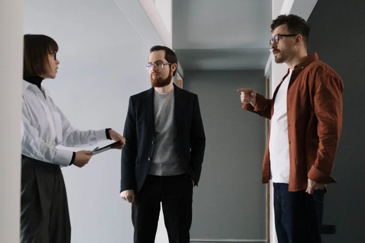 An image of tenants discussing a topic with the landlord