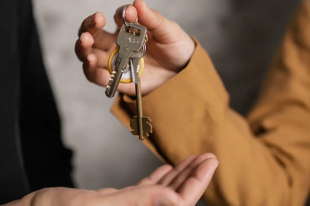 An image of a landlord handing over keys