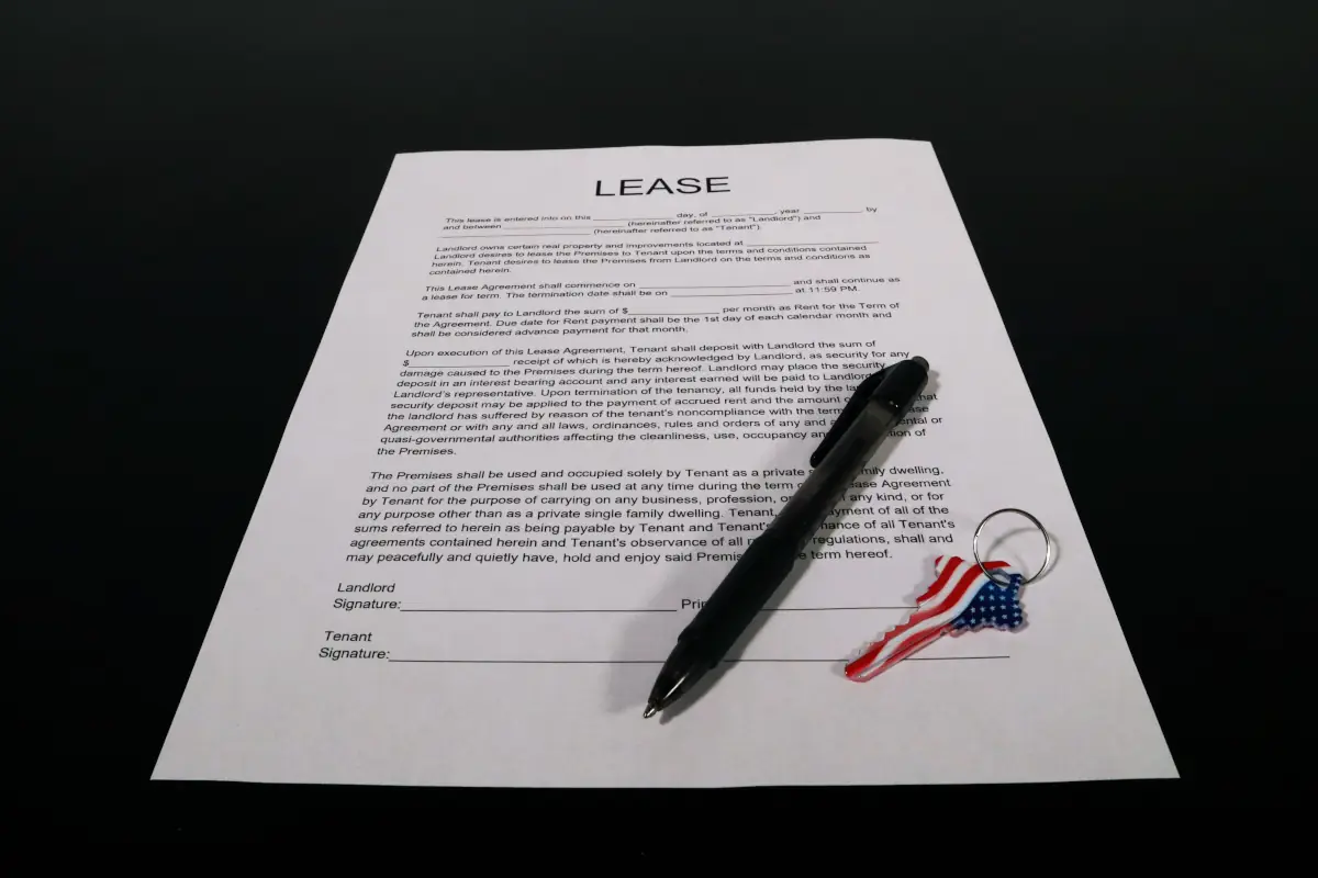 An image of a lease agreement with a pen and keys
